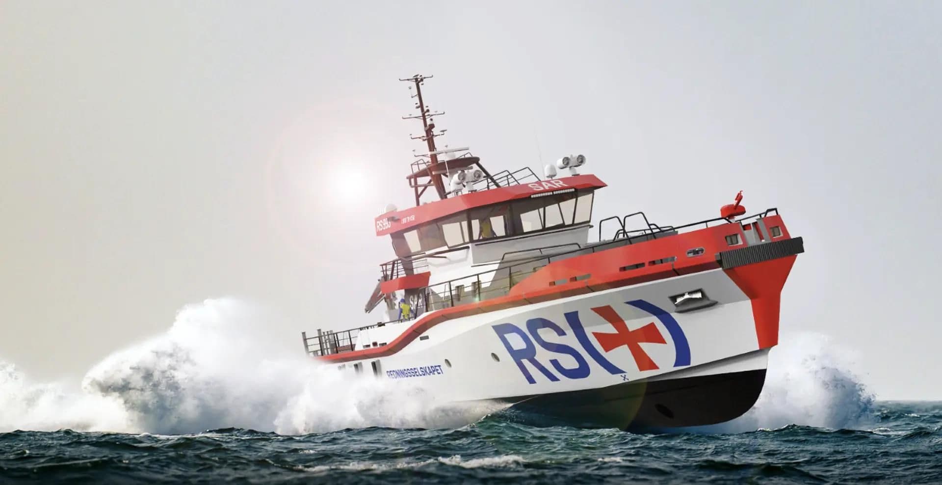 A red and white Redningsselskapet rescue vessel running through heavy spray